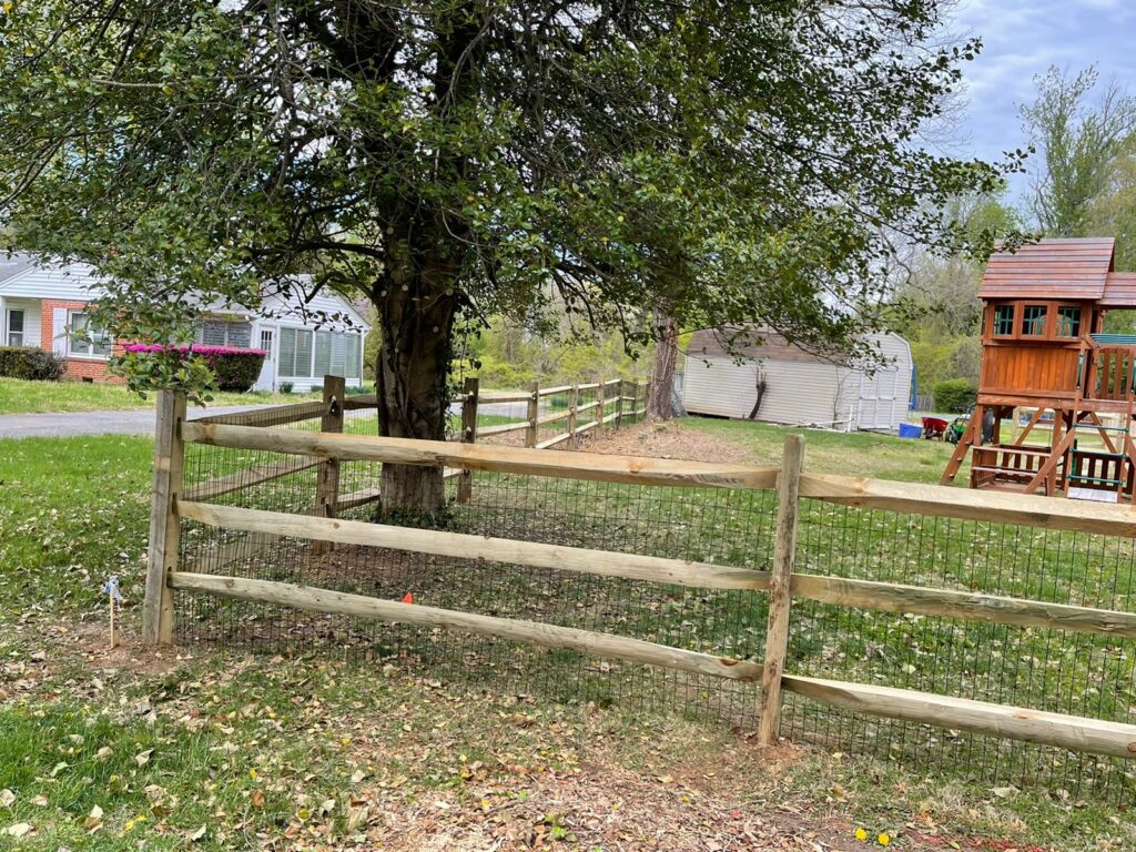 Split rail wood fence along a front yard