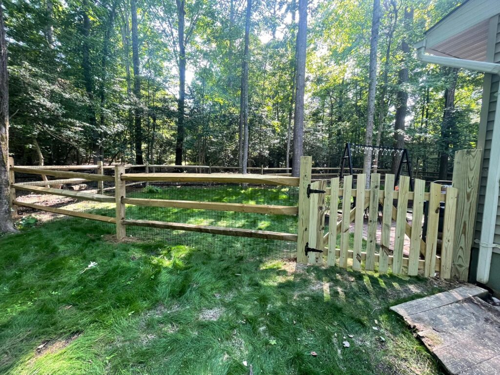 Split rail wood fence with a picket gate section in a shaded yard