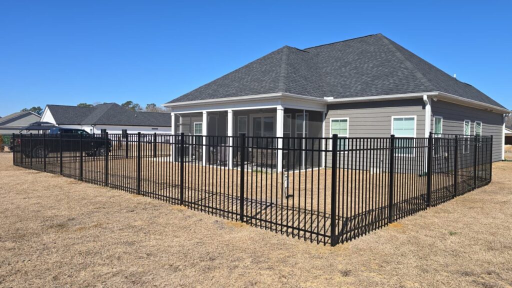 Black aluminum fence around the backyard of a new home