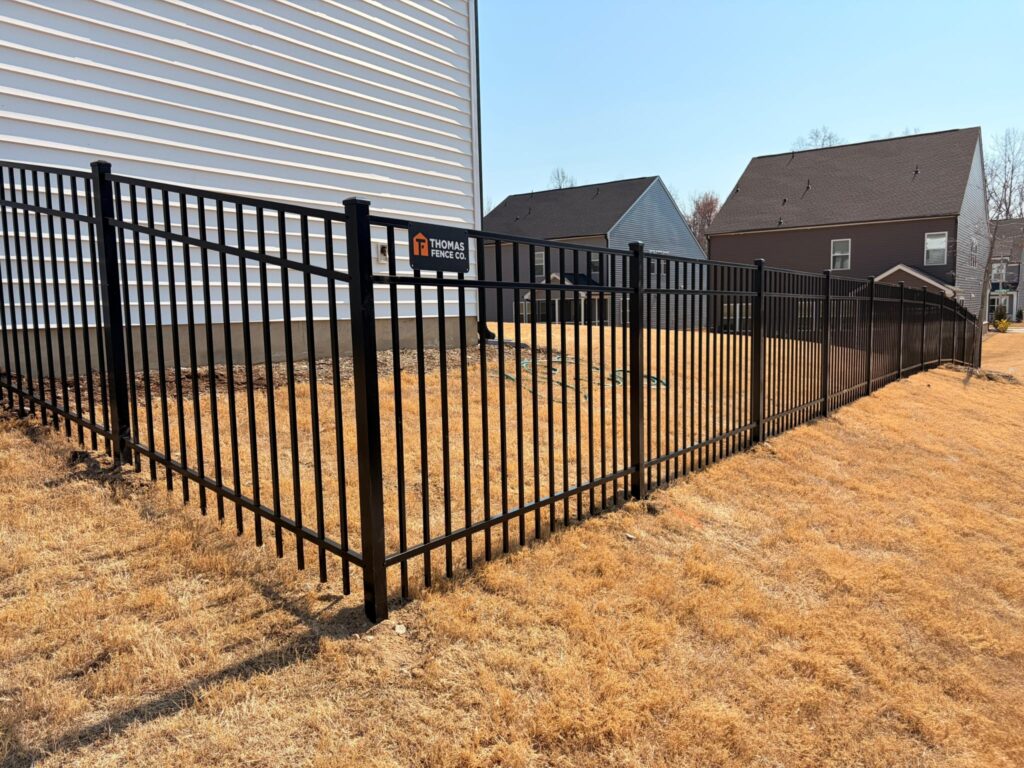 Black aluminum fence around a new backyard