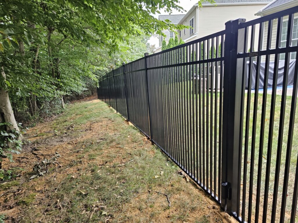 Black aluminum fence along a wooded lot in Raleigh, NC