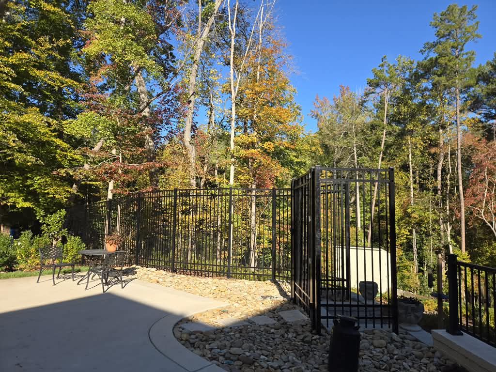 Black aluminum fence enclosing a patio