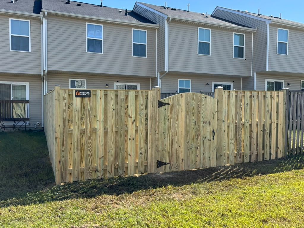 New wood privacy fence behind townhouses
